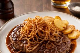 Zwiebelrostbraten u tamnom sosu sa hrskavim lukom i zapečenim krompirom