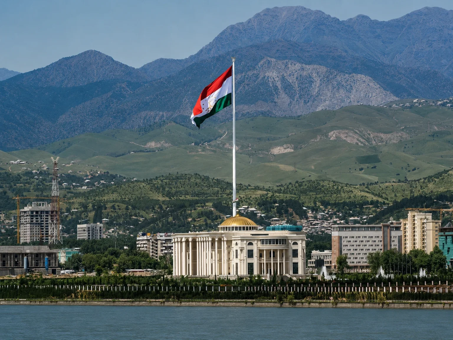 杜尚别巨型国旗前的白色政府建筑与山地背景